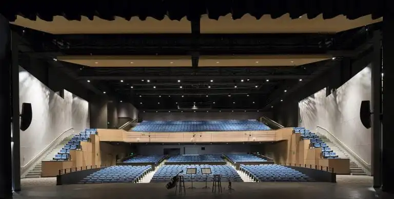 Empty auditorium with blue seating.