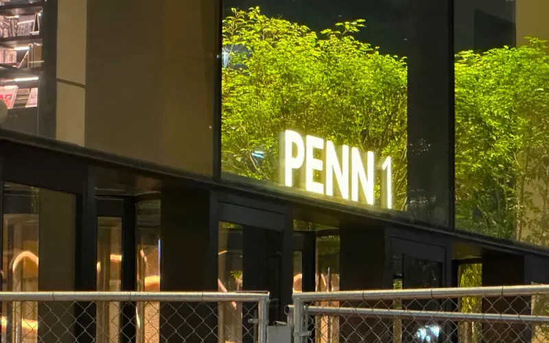 Building with illuminated sign 'PENN 1'